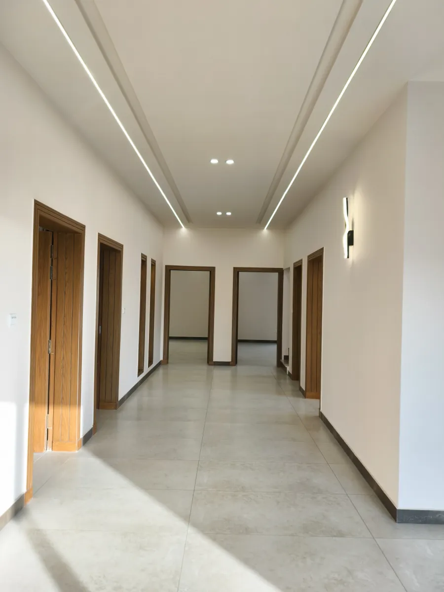 Bedroom corridor under continuous cove lighting