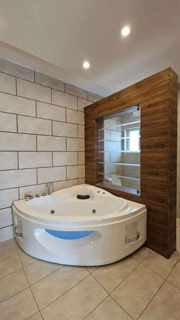 Master bathroom with luxury corner jacuzzi