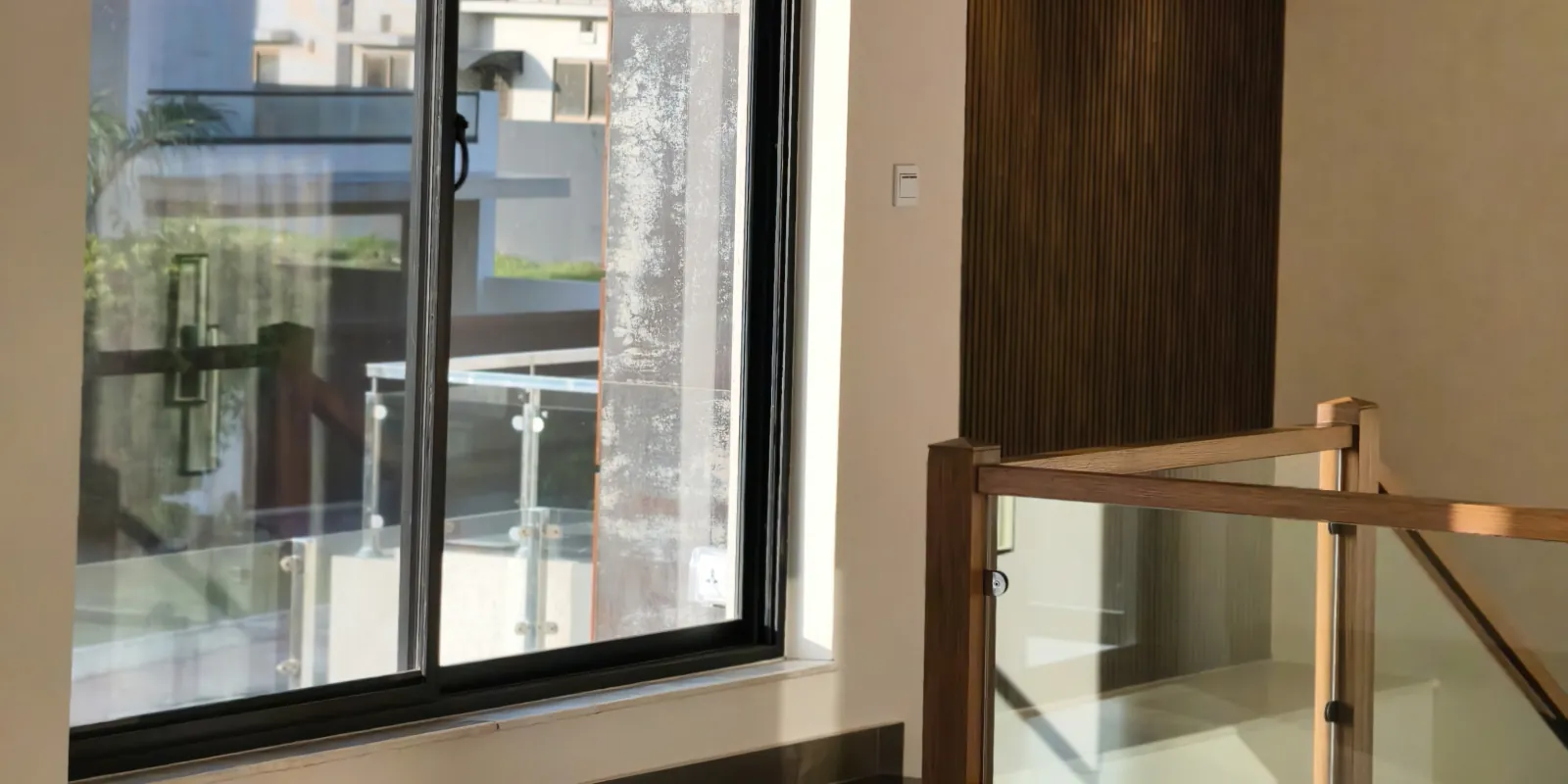 Finished interior landing with timber and glass balustrade